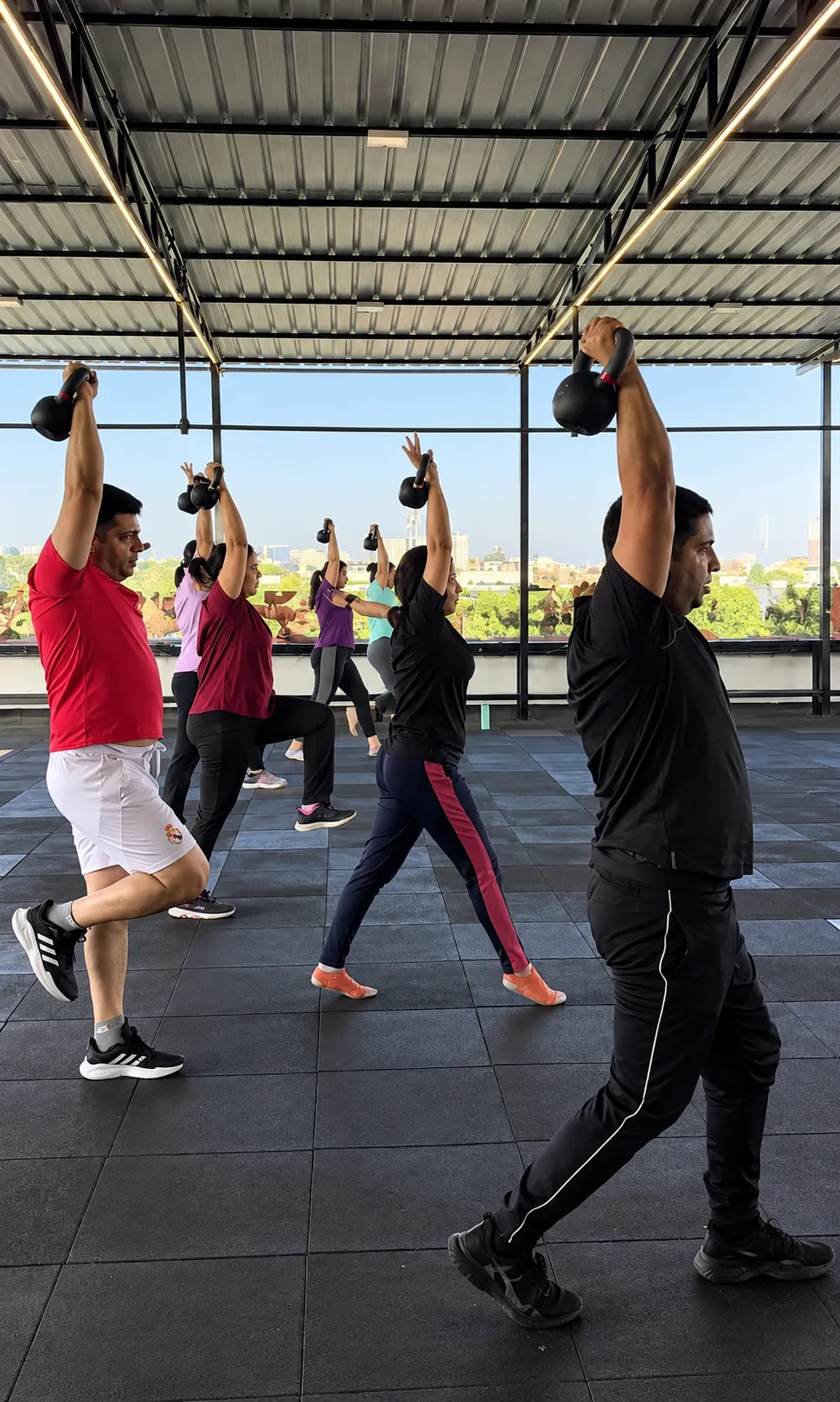 Kettlebell lunge class on a rooftop gym